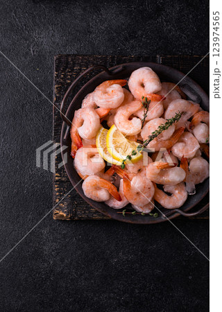 Frozen uncooked prawns or shrimps with lemon 123974565