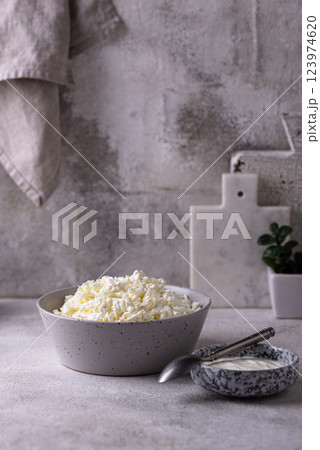 Cottage cheese on light background Cottage cheese on light background 123974620