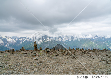 Stone Cairns Stand Tall Against a Backdrop of Majestic Mountain Ranges 123974849
