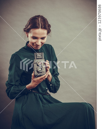Woman retro style with old camera Woman retro style with old camera 123978686