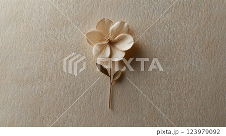 Delicate paper flower with leaves on textured beige background 123979092