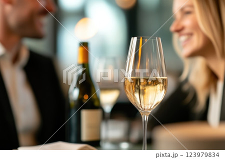 Friendly dinner gathering with wine glasses and bottles on the table Friendly dinner gathering with wine glasses and bottles on the table 123979834