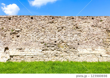 Rough stone wall of the ancient medieval fortress Izborsk Rough stone wall of the ancient medieval fortress Izborsk 123980698