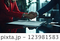 Closeup two business partners doing handshake over desk after signing contract, showing elegance and trust. Handshake symbolizes partnership, cooperation, handshake seals the deal. 123981583