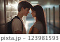 Teenage romance captured school hallway atmosphere, sweet moment between young couple, first feelings romance sharing looks silently, gentle lighting highlighting innocent teenage romance. 123981593