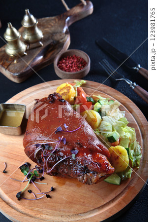 Pork knuckle baked with potatoes and spices. An appetizer for beer. German cuisine. Oktoberfest menu. Oktoberfest menu. 123981765