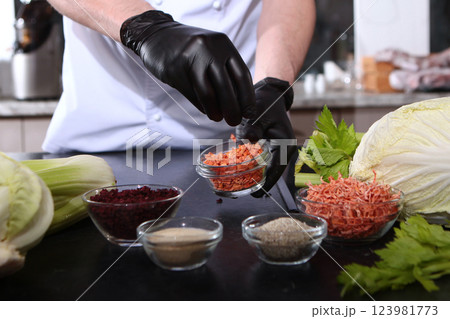 Dried vegetables for cooking. Cook holds finely chopped dried carrots in his hands. 123981773