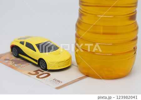 A bottle of vegetable oil and a typewriter lie on a banknote. Biodiesel, biofuel,  123982041