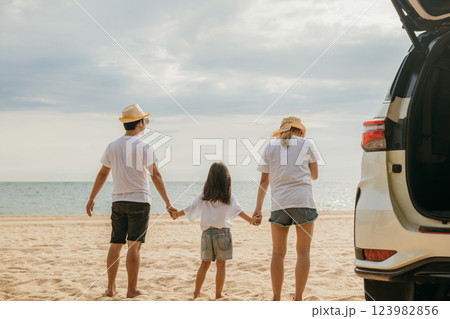 Happy Asian family walking hand in hand on sandy beach, Parents father and mother holding hands their children back car, holiday vacations summer road trip, Family day concept 123982856