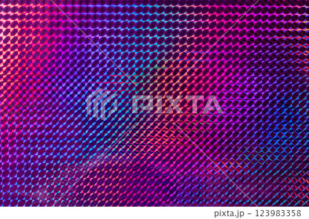 A vibrant, textured surface featuring a mesmerizing blend of purple, pink, and blue hues, reflecting light in a geometric pattern. 123983358