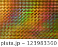 A vibrant, multicolored holographic surface featuring a pattern of raised diamond shapes, reflecting light and creating a dynamic visual effect. 123983360