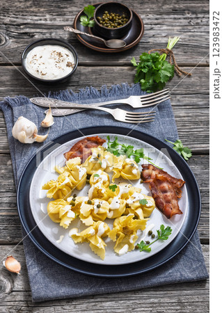 sacchettoni, pasta with bacon and cheese filling sacchettoni, pasta with bacon and cheese filling 123983472