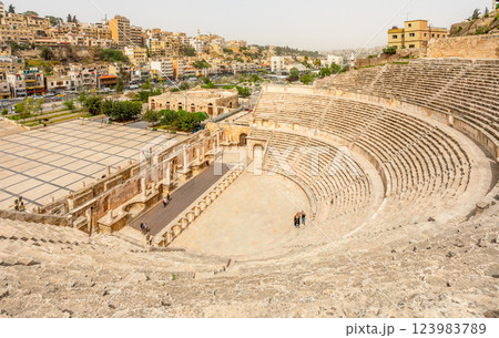 Ancient roman amphitheater arena and many residential houses on the hills in Al Balad downtown of Amman city, Kingdom of Jordan Ancient roman amphitheater arena and many residential houses on the hills in Al Balad downtown of Amman city, Kingdom of Jordan 123983789