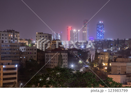 Night panorama of Amman city downtown streets with neon glowing skyscrapers, Kingdom of Jordan Night panorama of Amman city downtown streets with neon glowing skyscrapers, Kingdom of Jordan 123983799