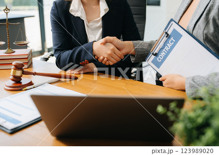 Consultation between a male lawyer and business customer, handshake after good deal agreement, Law and Legal Consultation between a male lawyer and business customer, handshake after good deal agreement, Law and Legal 123989020
