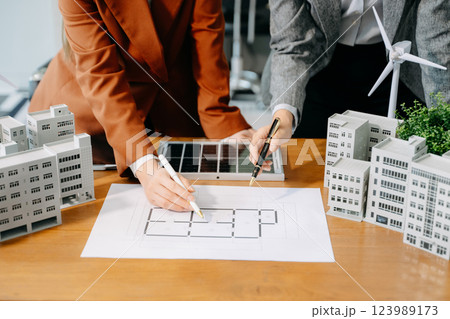 Modern office meeting of architects, designers, and developers creating innovative, sustainable housing projects 123989173