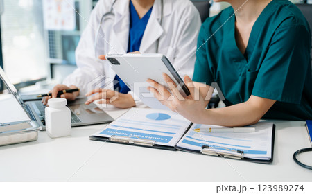 Medical technology network team meeting concept. Doctor hand working with smart phone modern digital tablet 123989274