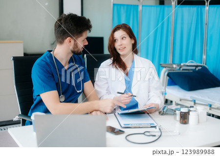 Doctors analyzing results or diagnosis of patient in clinic. Teamwork, medical and healthcare workers 123989988