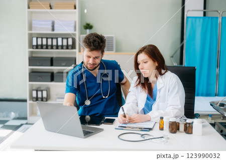 Doctors analyzing results or diagnosis of patient in clinic. Teamwork, medical and healthcare workers 123990032