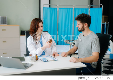 Portrait of female doctor explaining diagnosis to her patient. Doctor Meeting With Patient In Exam Room Portrait of female doctor explaining diagnosis to her patient. Doctor Meeting With Patient In Exam Room 123990059