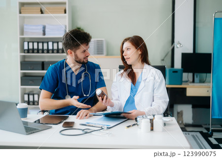 Doctors analyzing results or diagnosis of patient in clinic. Teamwork, medical and healthcare workers Doctors analyzing results or diagnosis of patient in clinic. Teamwork, medical and healthcare workers 123990075