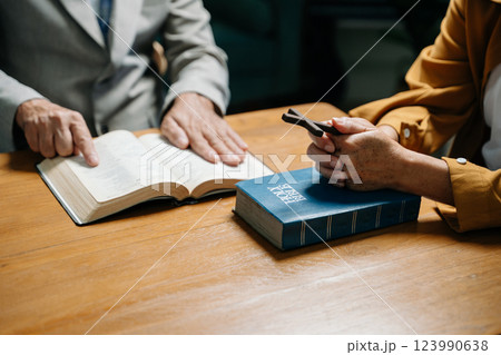 Two people reading and study bible in home and pray together.Studying the Word Of God 123990638