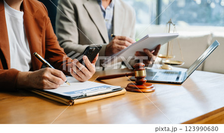 business people and lawyers discussing contract papers sitting at the table. Concepts 123990680