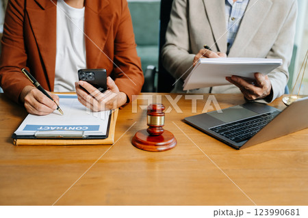 business people and lawyers discussing contract papers sitting at the table. Concepts 123990681