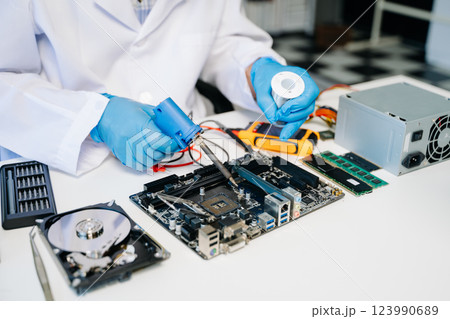 The technician repairing the motherboard in the lab with copy space. the concept 123990689