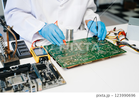 The technician repairing the motherboard in the lab with copy space. the concept The technician repairing the motherboard in the lab with copy space. the concept 123990696