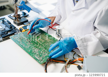 The technician repairing the motherboard in the lab with copy space. the concept 123990721