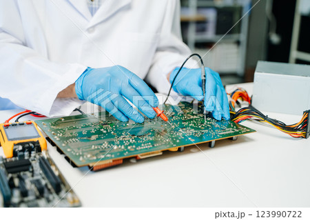 The technician repairing the motherboard in the lab with copy space. the concept The technician repairing the motherboard in the lab with copy space. the concept 123990722