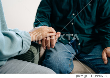 Hands of the old man and a woman hand on the table Hands of the old man and a woman hand on the table 123990729
