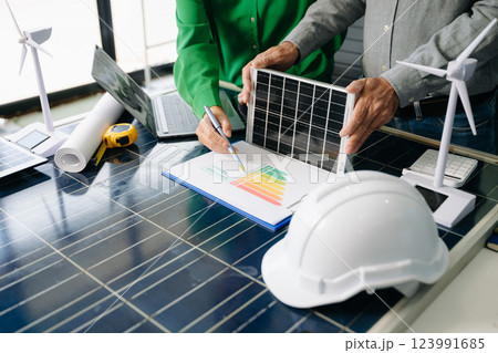 Engineers collaborate on solar and wind energy, driving sustainability, innovation, and clean tech solutions. 123991685