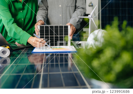 Engineers collaborate on solar and wind energy, driving sustainability, innovation, and clean tech solutions. 123991686