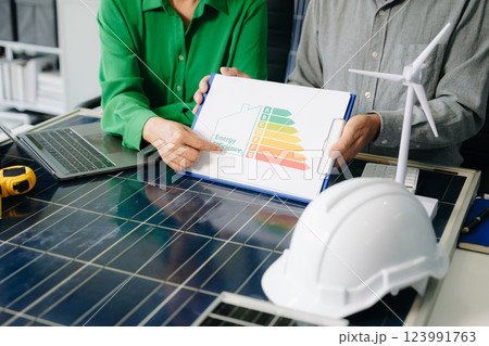 Engineers collaborate on solar and wind energy, driving sustainability, innovation, and clean tech solutions. Engineers collaborate on solar and wind energy, driving sustainability, innovation, and clean tech solutions. 123991763
