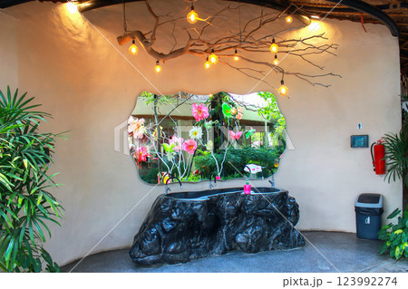 An artistic restroom area combines nature, functionality, and enchanting decorative elements. An artistic restroom area combines nature, functionality, and enchanting decorative elements. 123992274