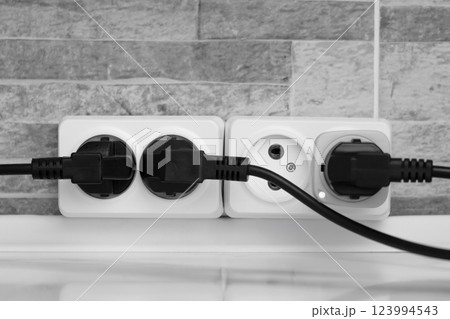 electrical white socket with black plugs 123994543