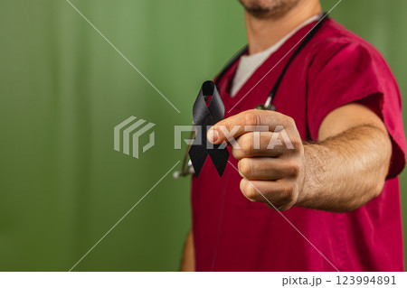 Healthcare professional holds black ribbon in honor of remembrance 123994891