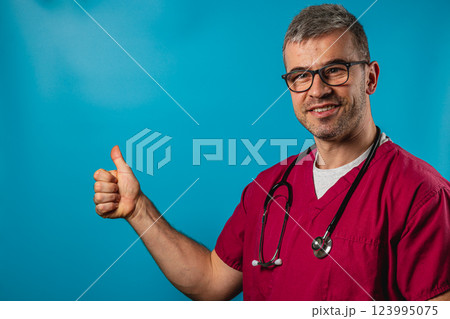 Healthcare professional gives a thumbs up in a medical setting 123995075