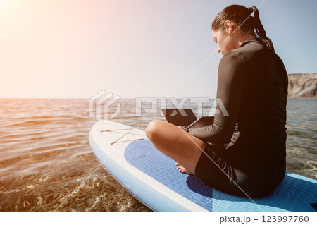 Woman Laptop Paddleboard Working Remotely Ocean Beach Woman Laptop Paddleboard Working Remotely Ocean Beach 123997760