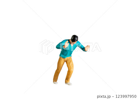 Miniature Figurine Pushing Against Invisible Force isolated on white background with clipping path 123997950