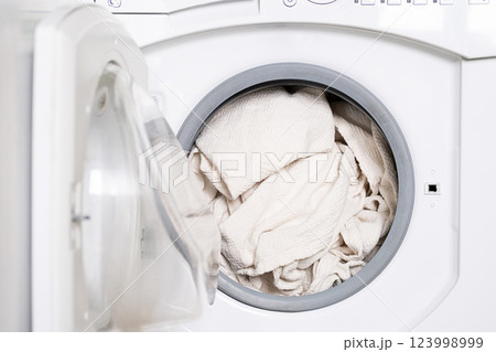 Clothes In The Laundry Machine. Clothes In The Laundry Machine. 123998999