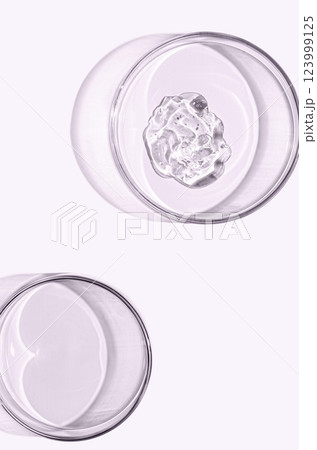A sample of skin serum or moisturizing gel in a Petri dish. A cosmetic product. A sample of skin serum or moisturizing gel in a Petri dish. A cosmetic product. 123999125
