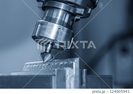The angular milling process on NC milling machine with chamfer tools in the light blue scene. The angular milling process on NC milling machine with chamfer tools in the light blue scene. 124005941