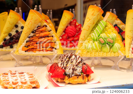 Belgian waffles with colorful sweet toppings and fruits for sale in Brussels, Belgium Belgian waffles with colorful sweet toppings and fruits for sale in Brussels, Belgium 124006233