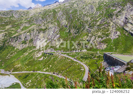Scenic view of Grimsel Pass winding through the majestic mountains of Switzerland Scenic view of Grimsel Pass winding through the majestic mountains of Switzerland 124006252