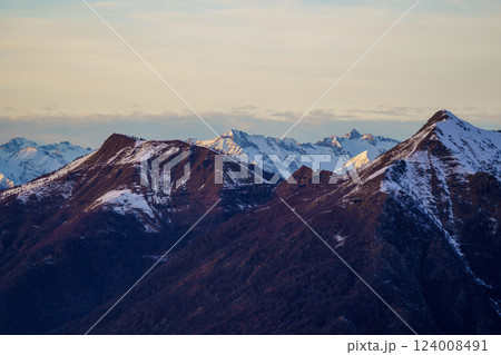 Snow-Dusted Mountain Peaks at Sunset near Piani di Bobbio in Italy 124008491