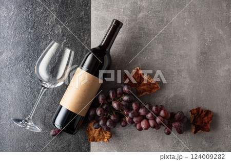 Red wine with grapes on a stone background. Red wine with grapes on a stone background. 124009282