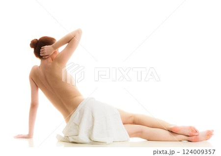 Sitting naked woman in white towel 124009357